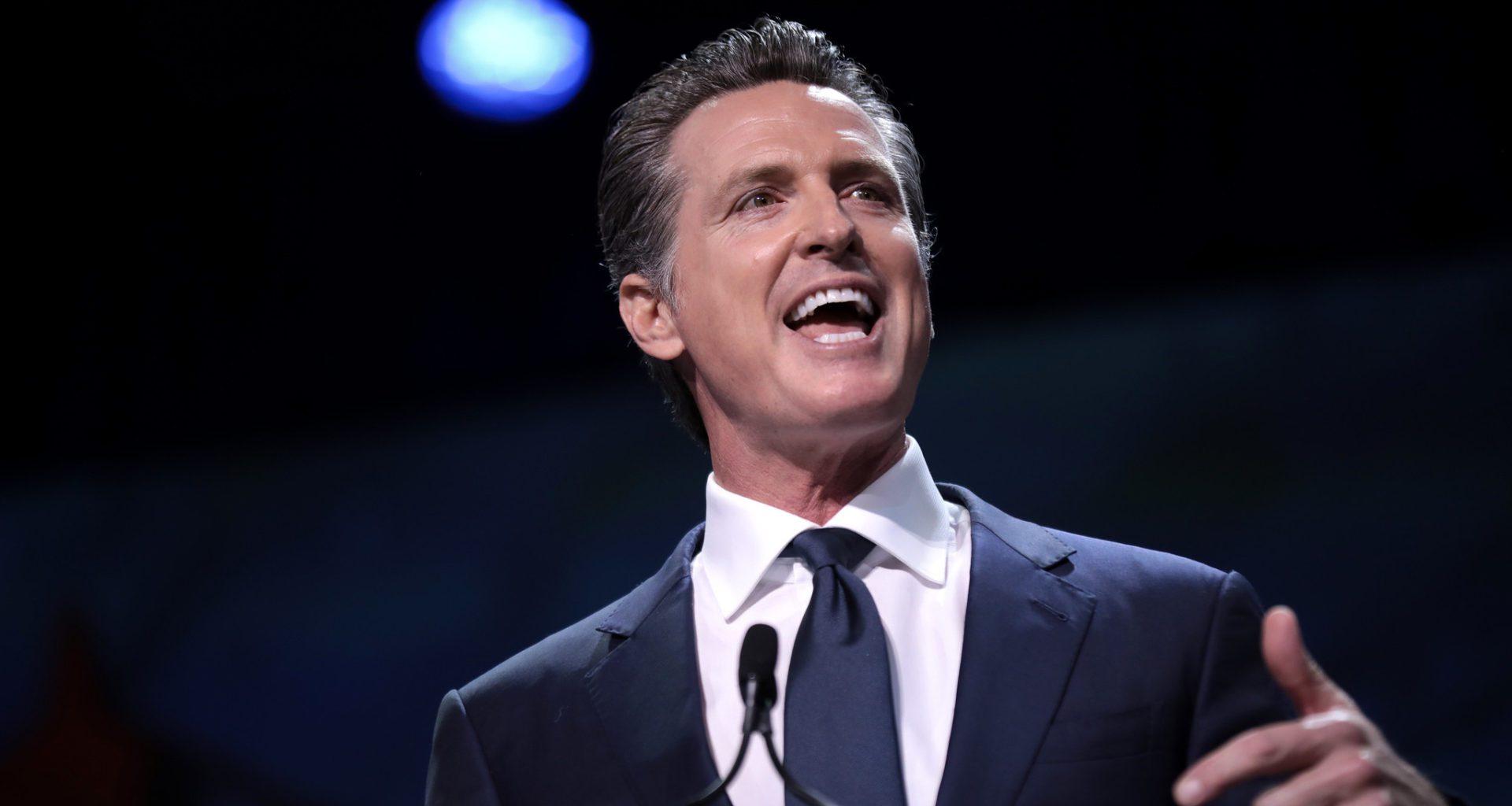 Photo of California Gov. Gavin Newsom speaking from a podium