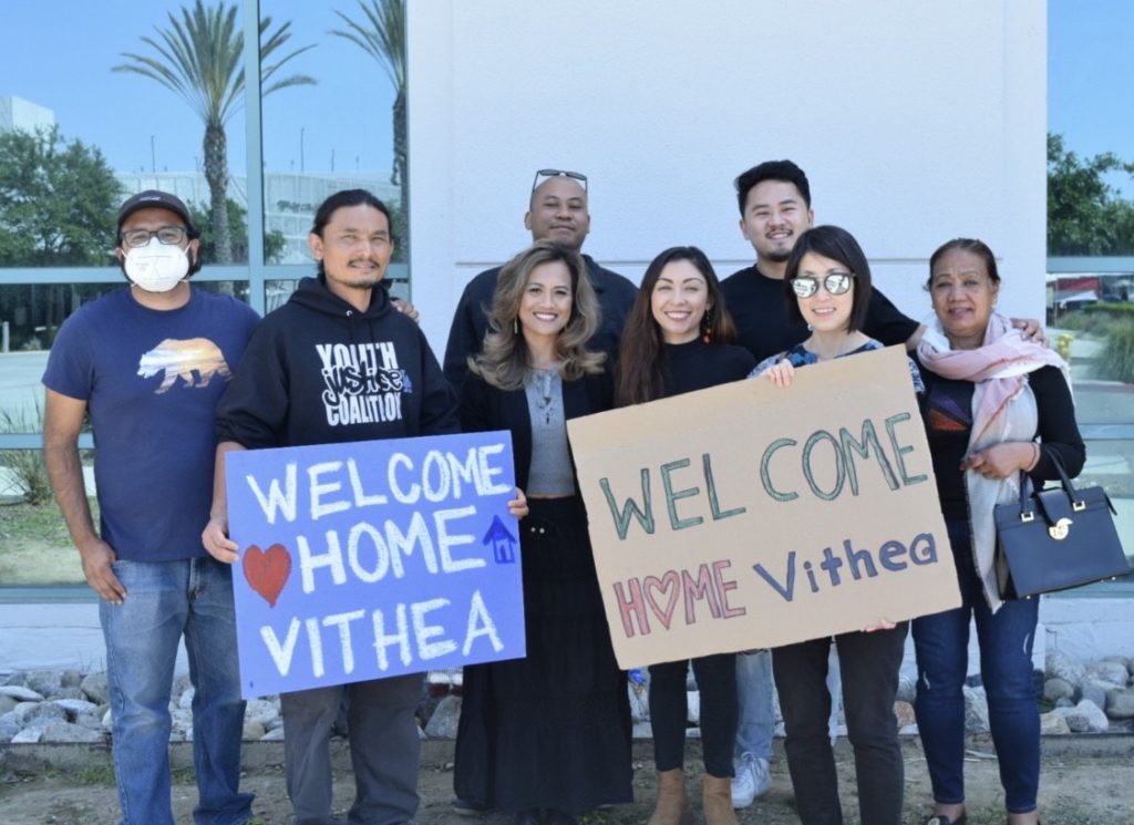 Photo of a group of people holding signs that say "Welcome home Vithea" as part of a demonstration against deportation of Southeast Asian refugees