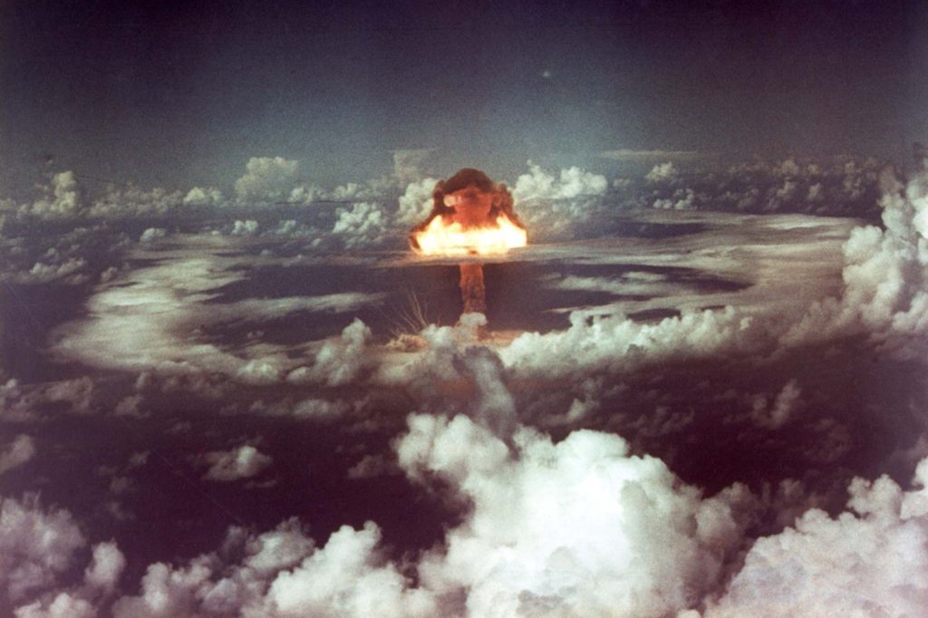 Photo of a nuclear bomb detonation over a Marshallese atoll