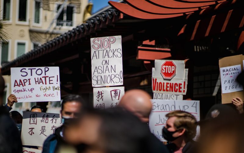 Protesters hold up signs at a 2021 rally against anti-Asian violence in San Francisco, California. Photo courtesy of Jason Leung via Unsplash.