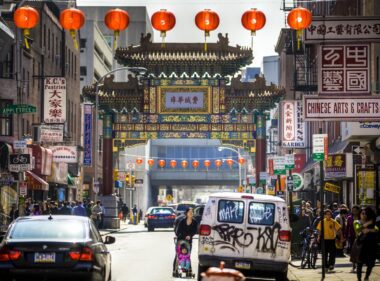 Photo of the gate to Philadelphia Chinatown with its ornate architecture and red lanterns strewn across the streets.