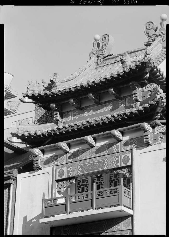 A black-and-white photo showing Chinese-style roof architecture on a block in Philadelphia's Chinatown.