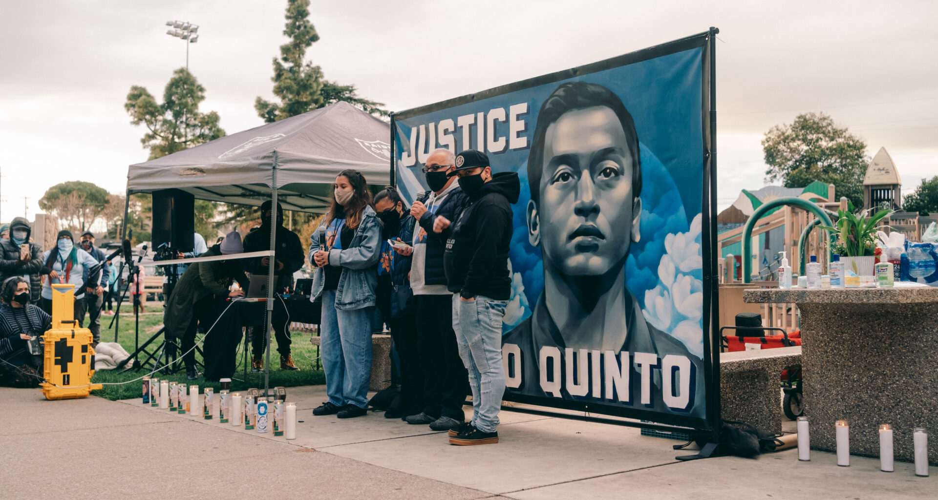 Photo of Angelo Quinto's family speaking out against police brutality at a vigil for Quinto