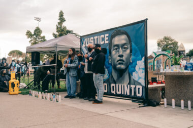 Photo of Angelo Quinto's family speaking out against police brutality at a vigil for Quinto
