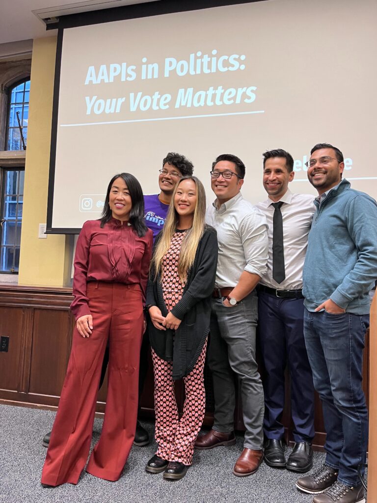 Photo of Annie Wu Henry standing with five other people in front of a presentation board that says "AAPIs in Politics: Your Vote Matters"