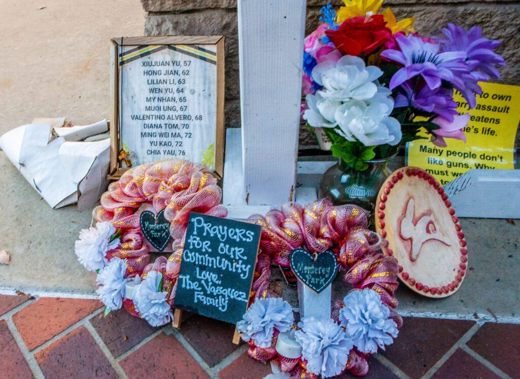 Photo showing a memorial with flowers and messages honoring victims of the Monterey Park shooting