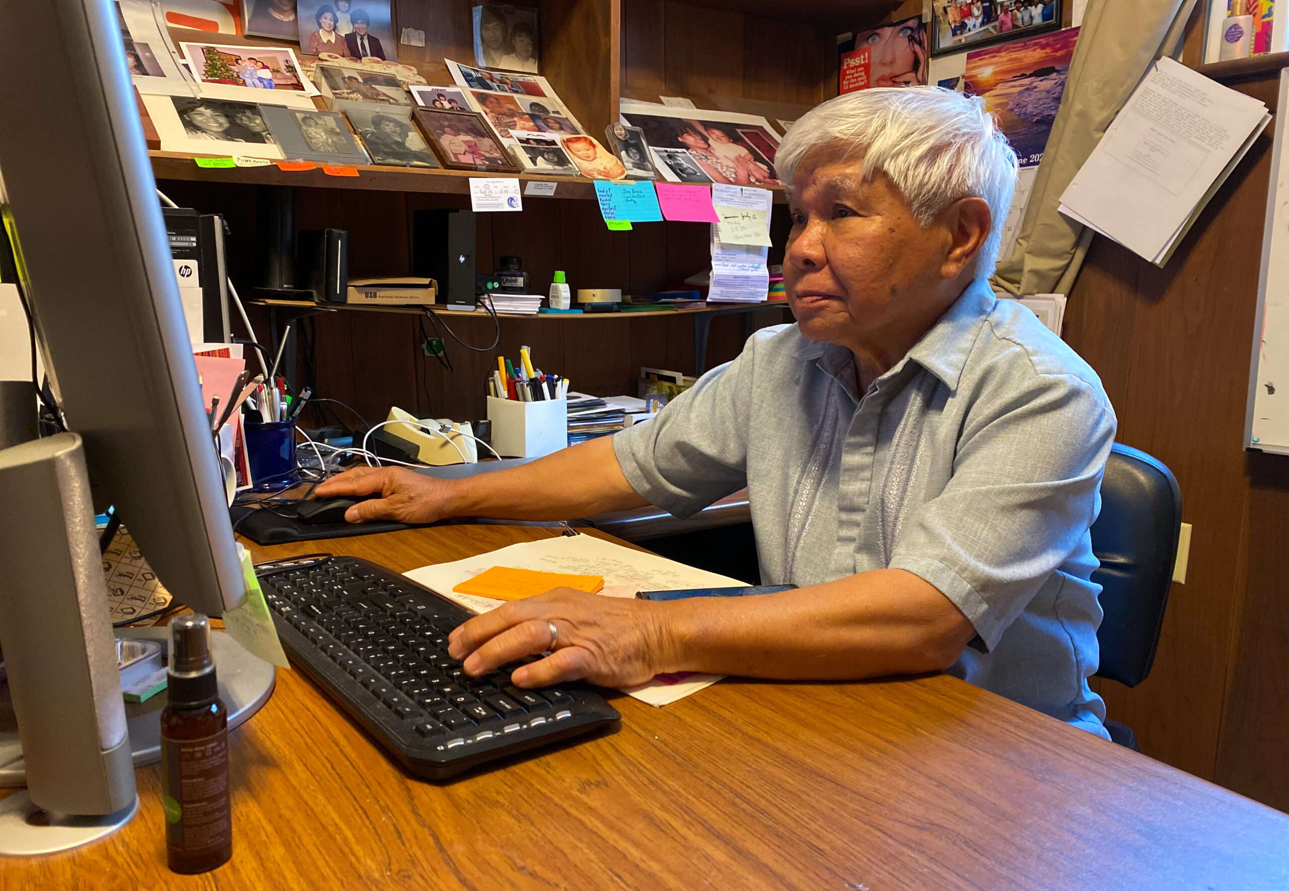 Photo of Jon Melegrito, former editor in chief of Manila Mail, sitting in front of a computer in his office