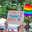 Photo of a sign reading "protect trans kids" at the 2018 Capital Pride Parade in Washington, D.C. as part of a rally for the right to gender-affirming care
