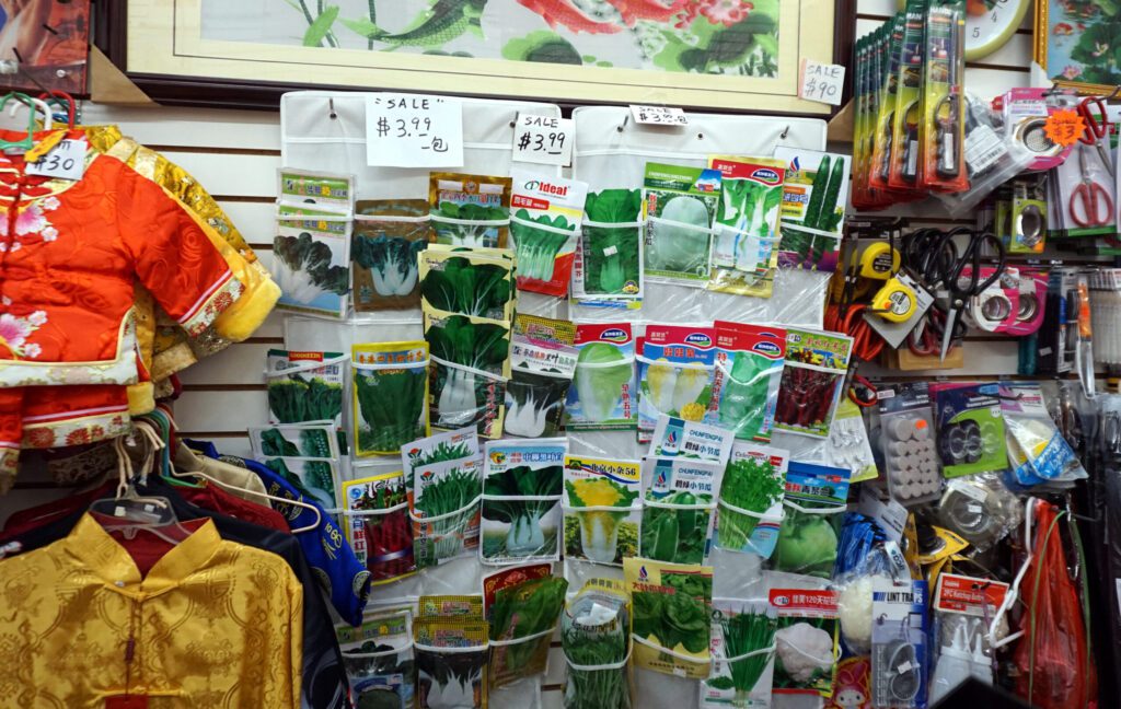 Photo of a convenience store in Chicago's Chinatown showing several packets of vegetable seeds and other products that meet environmental needs