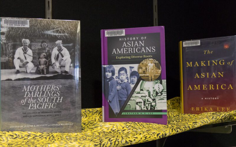 Photo of three AAPI-related books showcased on a table
