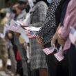 Photo of a naturalization ceremony on Citizenship Day, showing a row of people holding U.S. flags