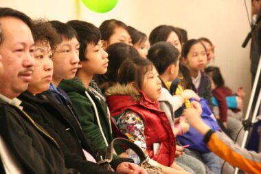 Photo of Hmong people sitting in a row