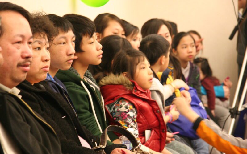 Photo of Hmong people sitting in a row