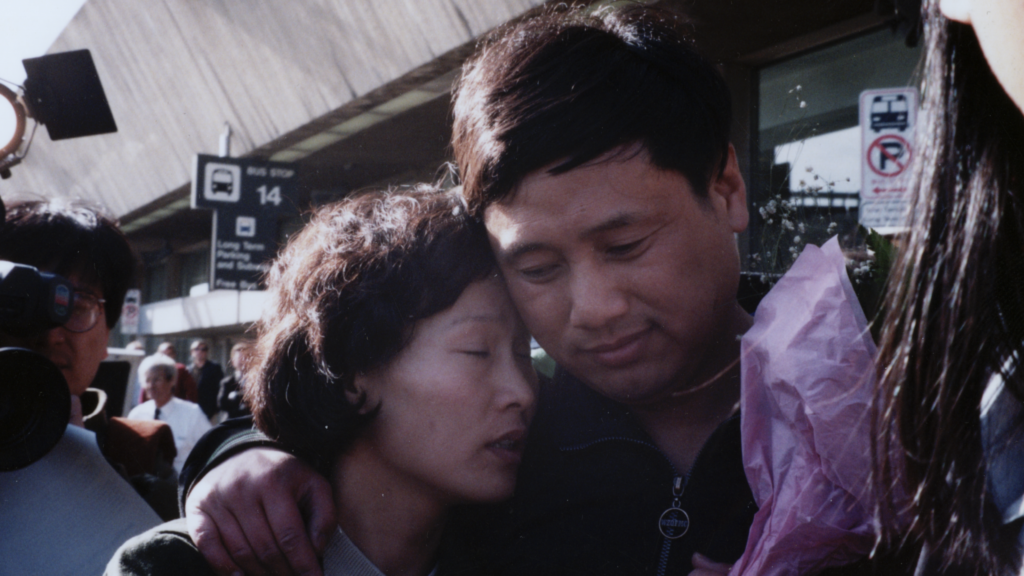 Photo of two Chinese people embracing