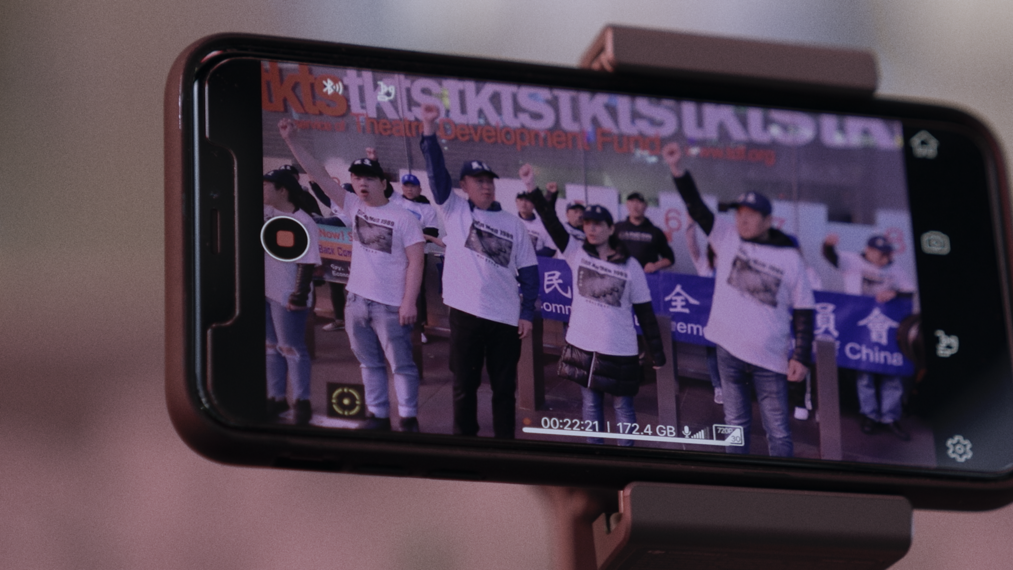 Image courtesy of a group of people protesting as shown on a phone screen