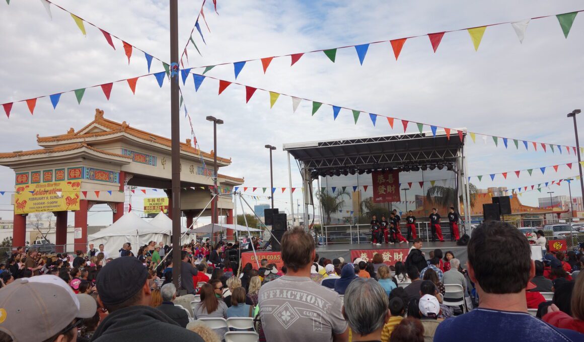 Photo of AAPIs gathered in front of a stage with performers at the Chinatown Plaza in Las Vegas, Nevada.