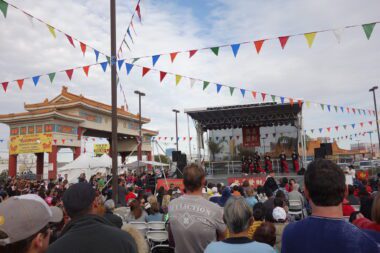 Photo of AAPIs gathered in front of a stage with performers at the Chinatown Plaza in Las Vegas, Nevada.