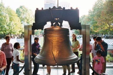 Photo of the cracked Liberty Bell in Philadelphia, Pennsylvania as tourists look on from the backdrop