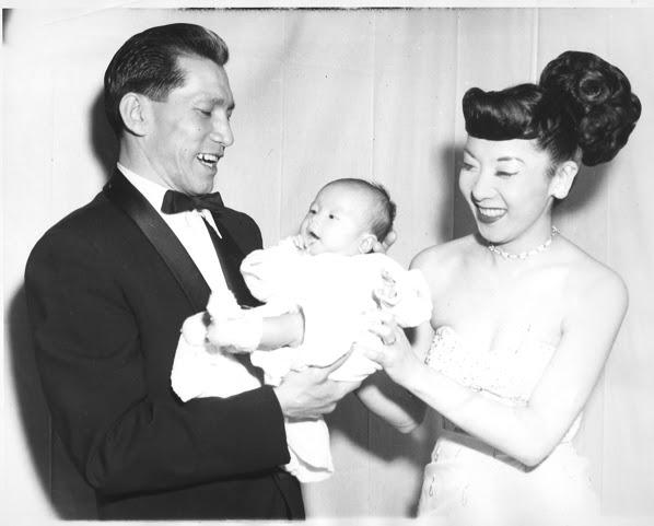 Jodi Long’s parents hold and smile at a baby