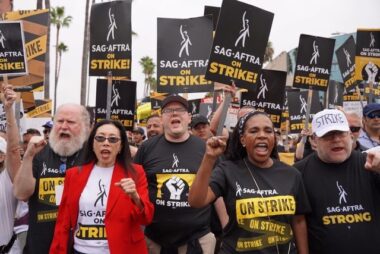 Photo of Jodi Long marching with other SAG-AFTRA union members on strike