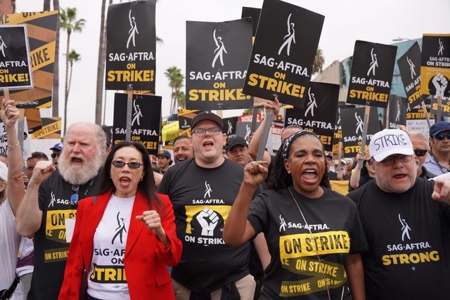 Photo of Jodi Long marching with other SAG-AFTRA union members on strike