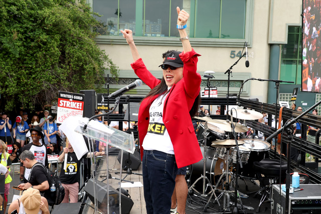 Photo of Jodi Long raising her arms in the air at a SAG-AFTA strike event